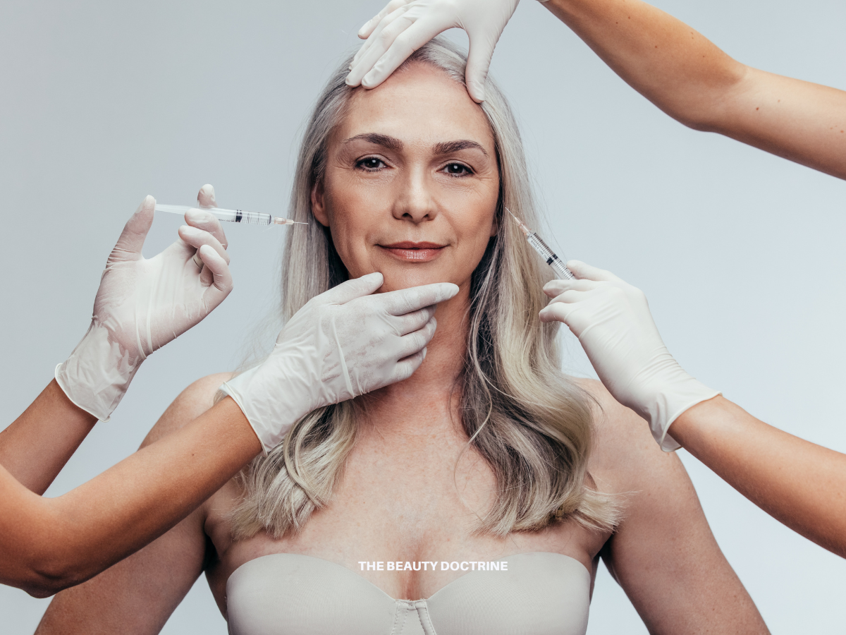 Woman examining skin in mirror — Botox science and long-term aging explained