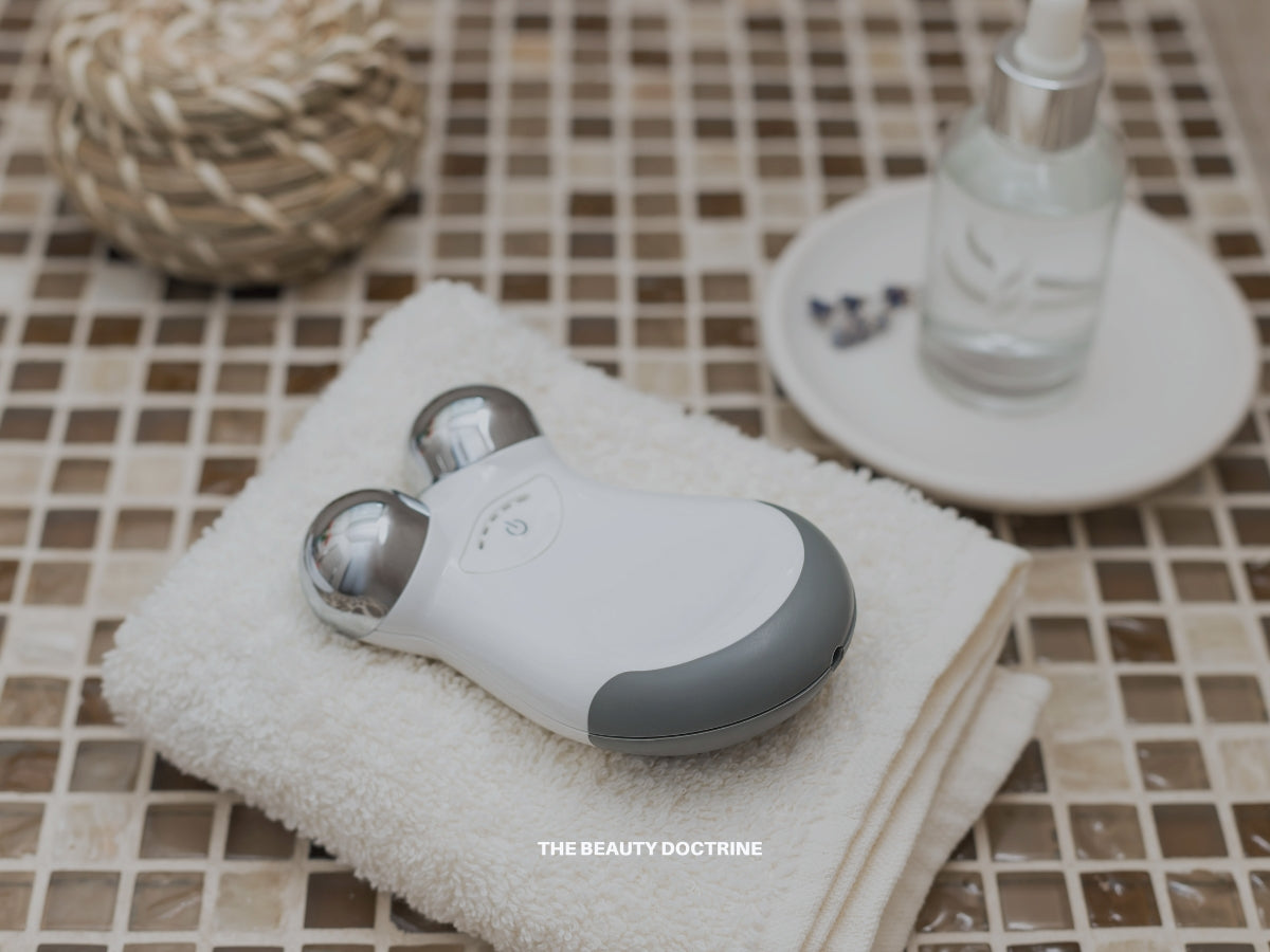 Woman using a microcurrent facial device for skin toning and anti-aging — The Beauty Doctrine guide