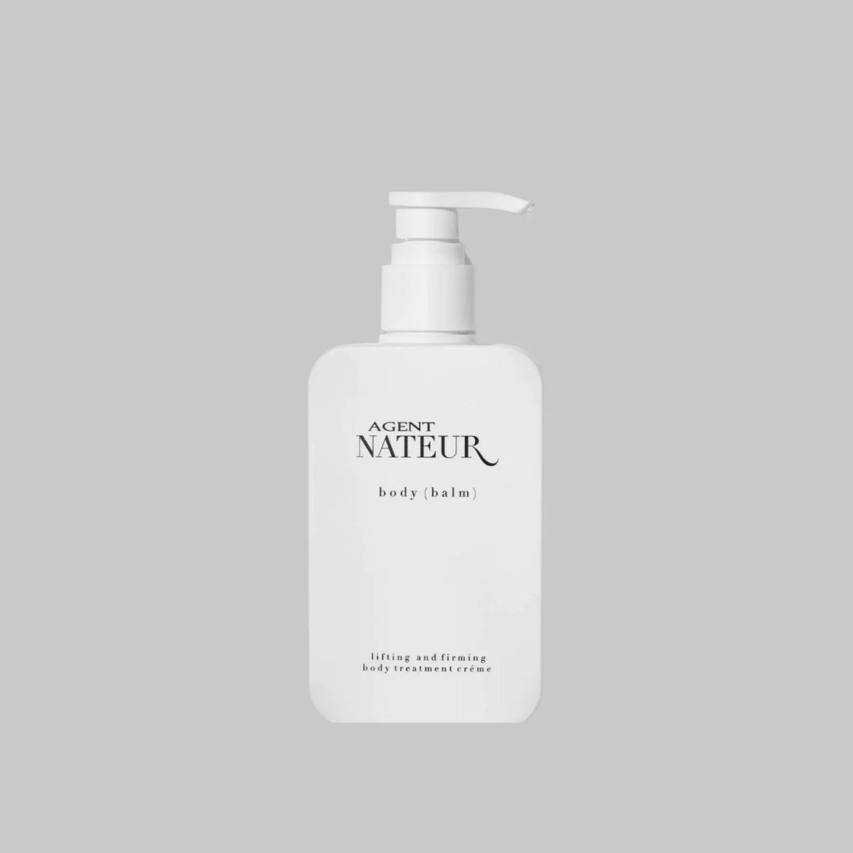 Agent Nateur Body (Balm) Ageless Body Treatment Crème in a white pump bottle on a gray background.