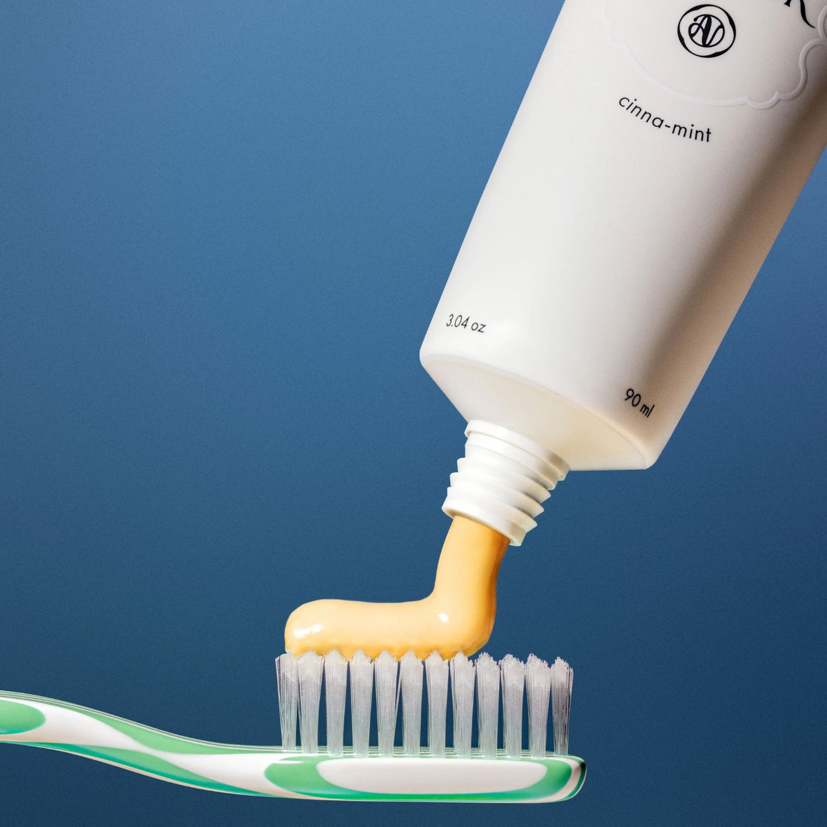 Agent Nateur holi (pearly) whites probiotic whitening toothpaste tube on a gray background
