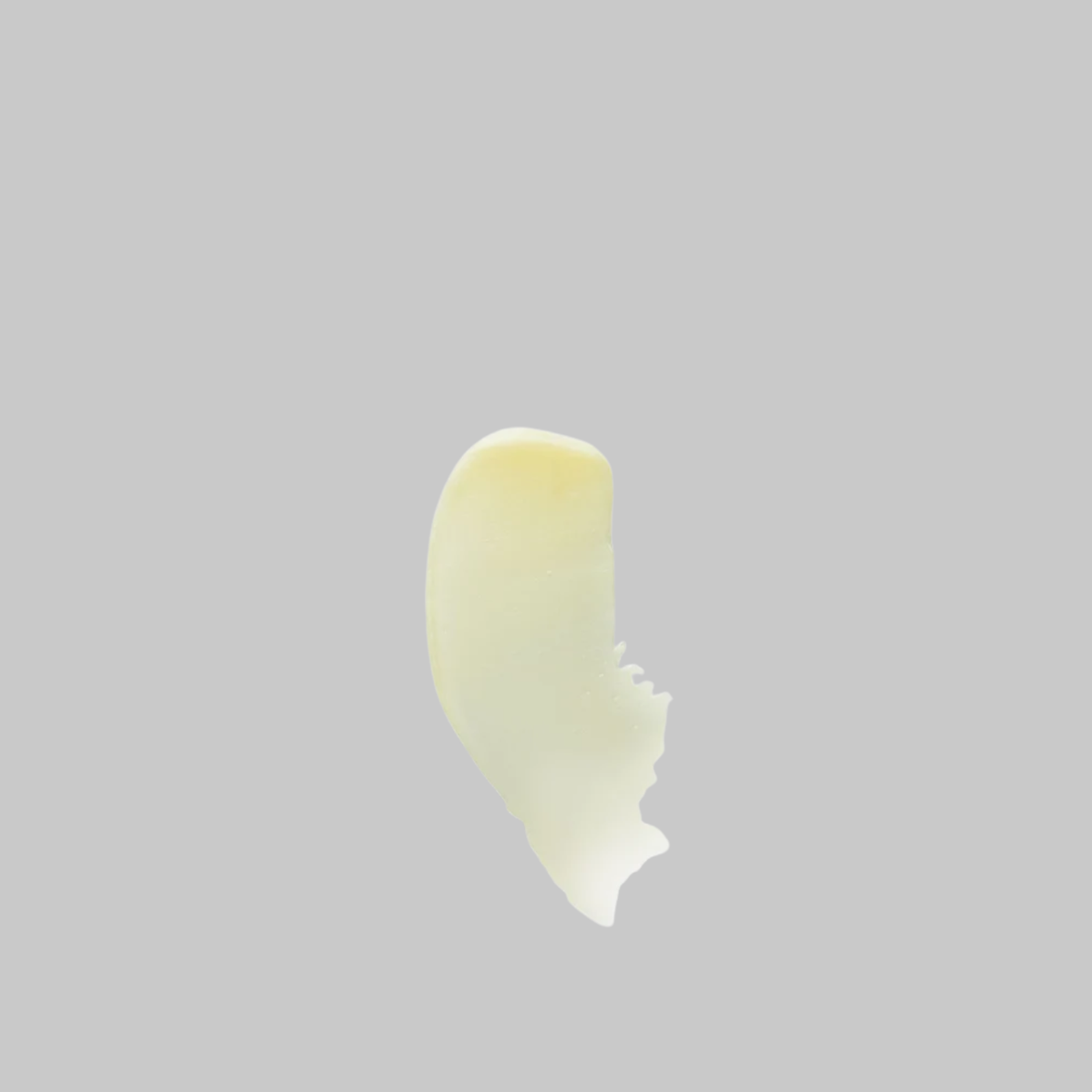 Pale yellow swatch of Bloomeffects Tulip Nectar Skin Repair Body Balm showing its thick, smooth texture.