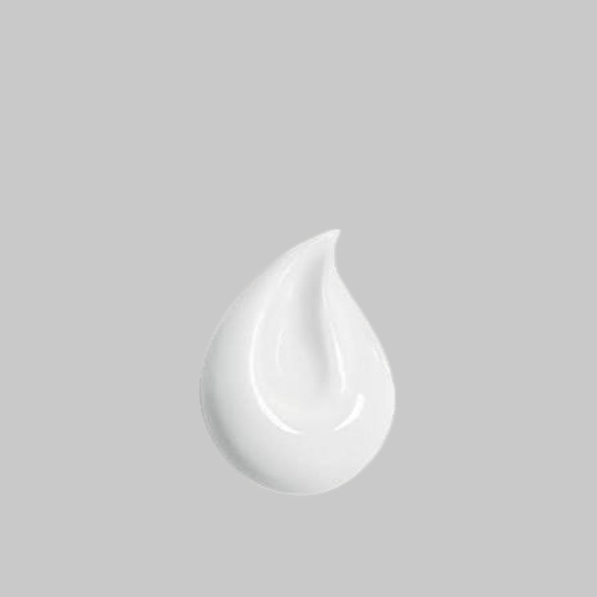 White, creamy swatch of Blübiome Hydrating Milk Cleanser on a gray background.