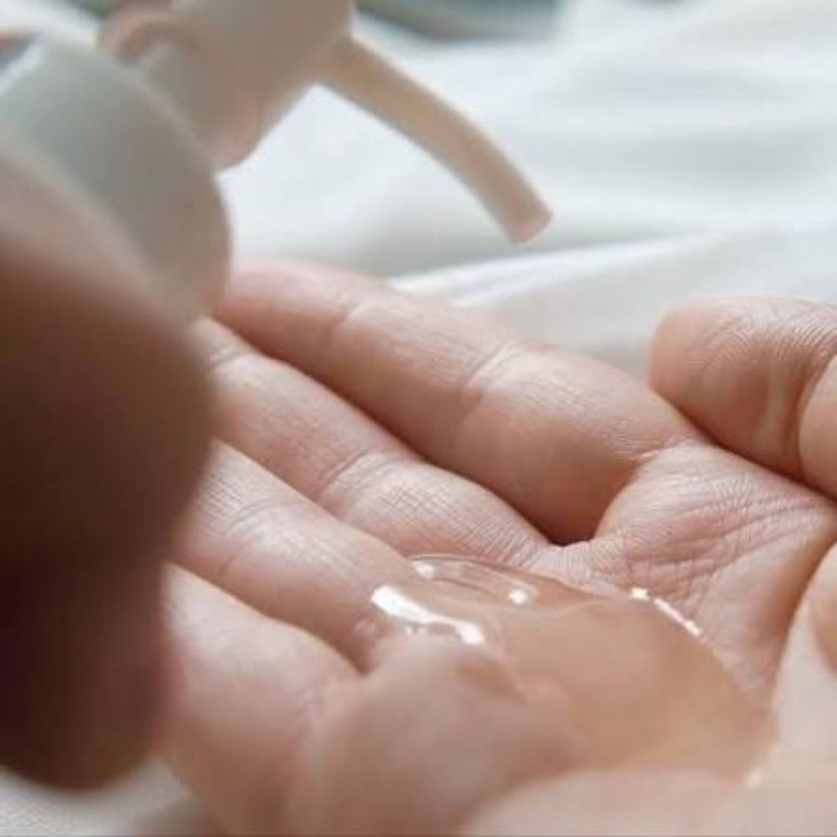 Blübiome Nourishing Oil Cleanser dispensed into a palm, showing its translucent oil texture.