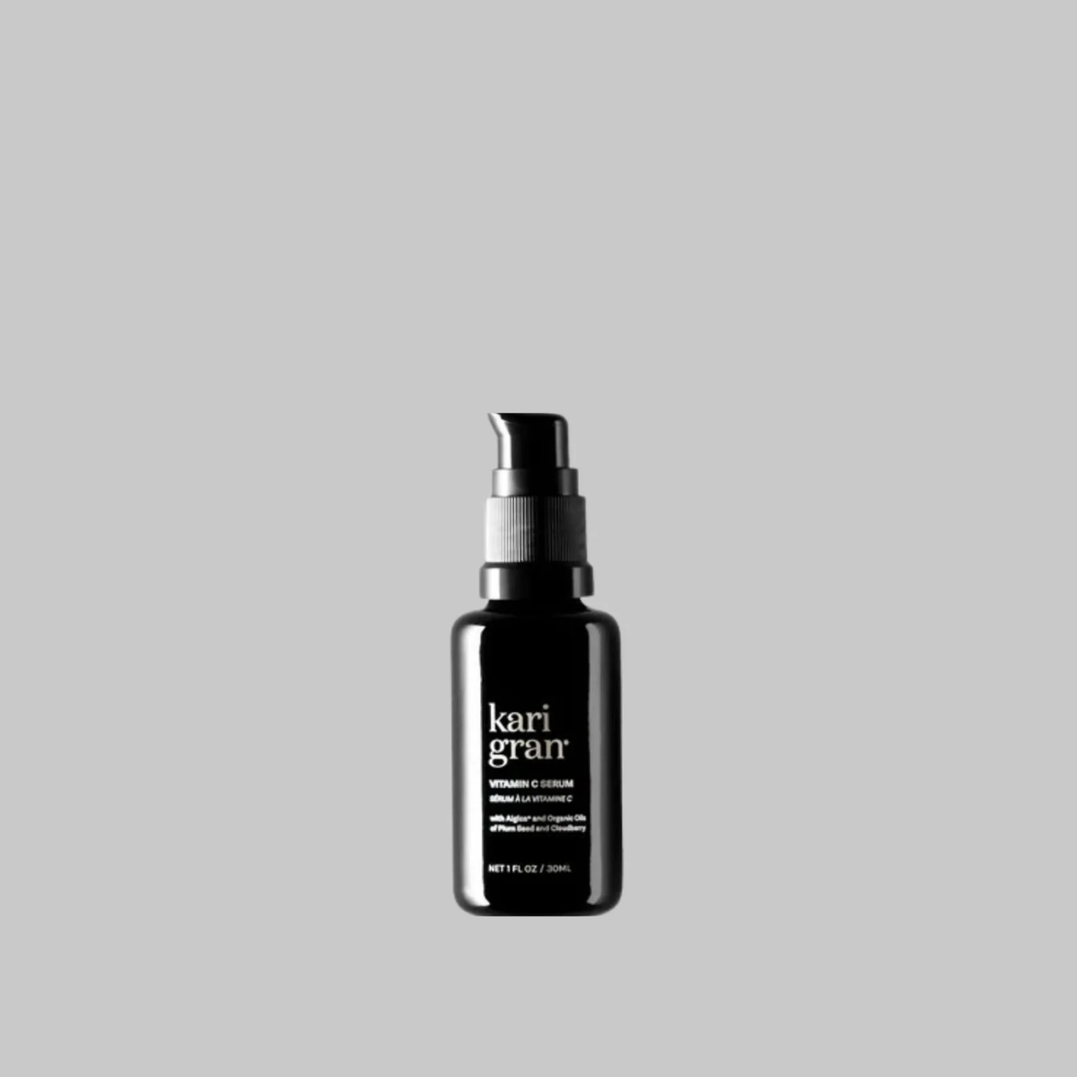 Kari Gran Vitamin C Serum in a black 30 ml pump bottle on a gray background.