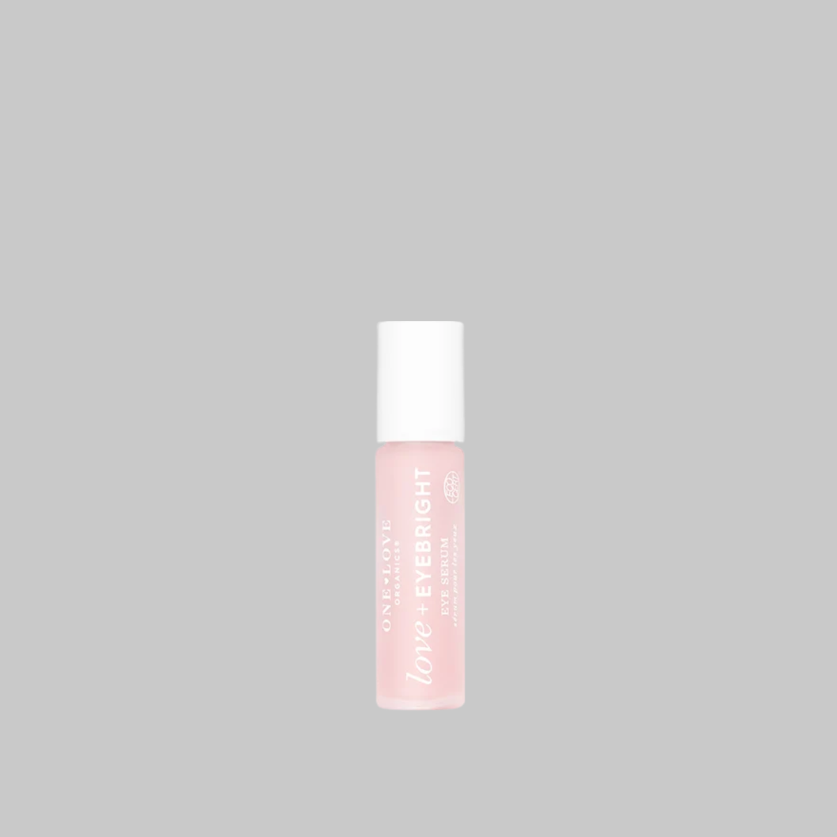 One Love Organics Love + Eyebright Eye Serum in a pink bottle with a white cap.