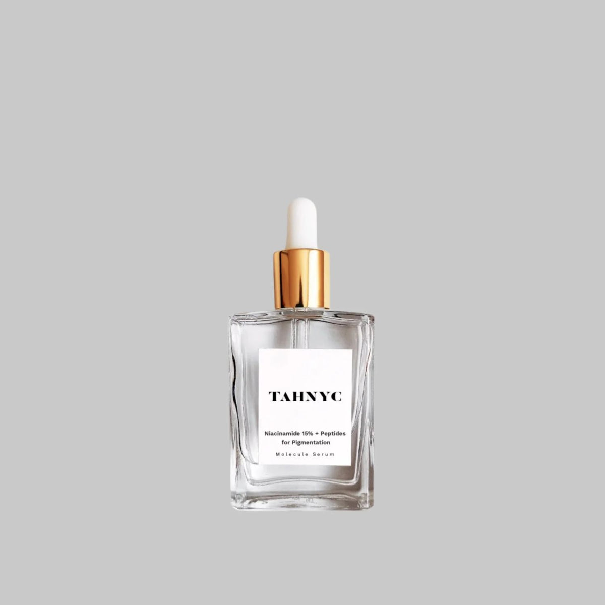 TAHNYC Niacinamide 15% + Peptides for Pigmentation face serum in a clear glass bottle with a gold and white dropper.