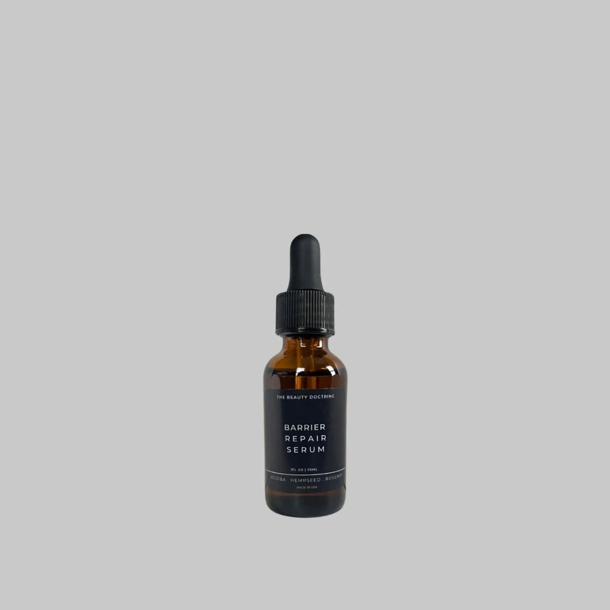 The Beauty Doctrine Barrier Repair Serum, 30 mL amber glass bottle with a black dropper on a gray background.