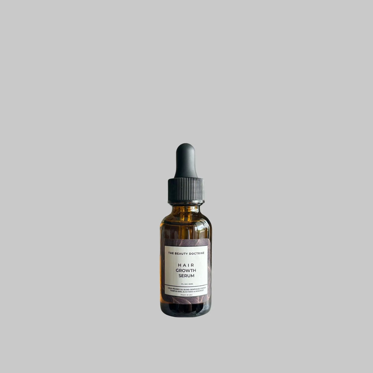 The Beauty Doctrine Hair Growth Serum in an amber dropper bottle, 30 mL.