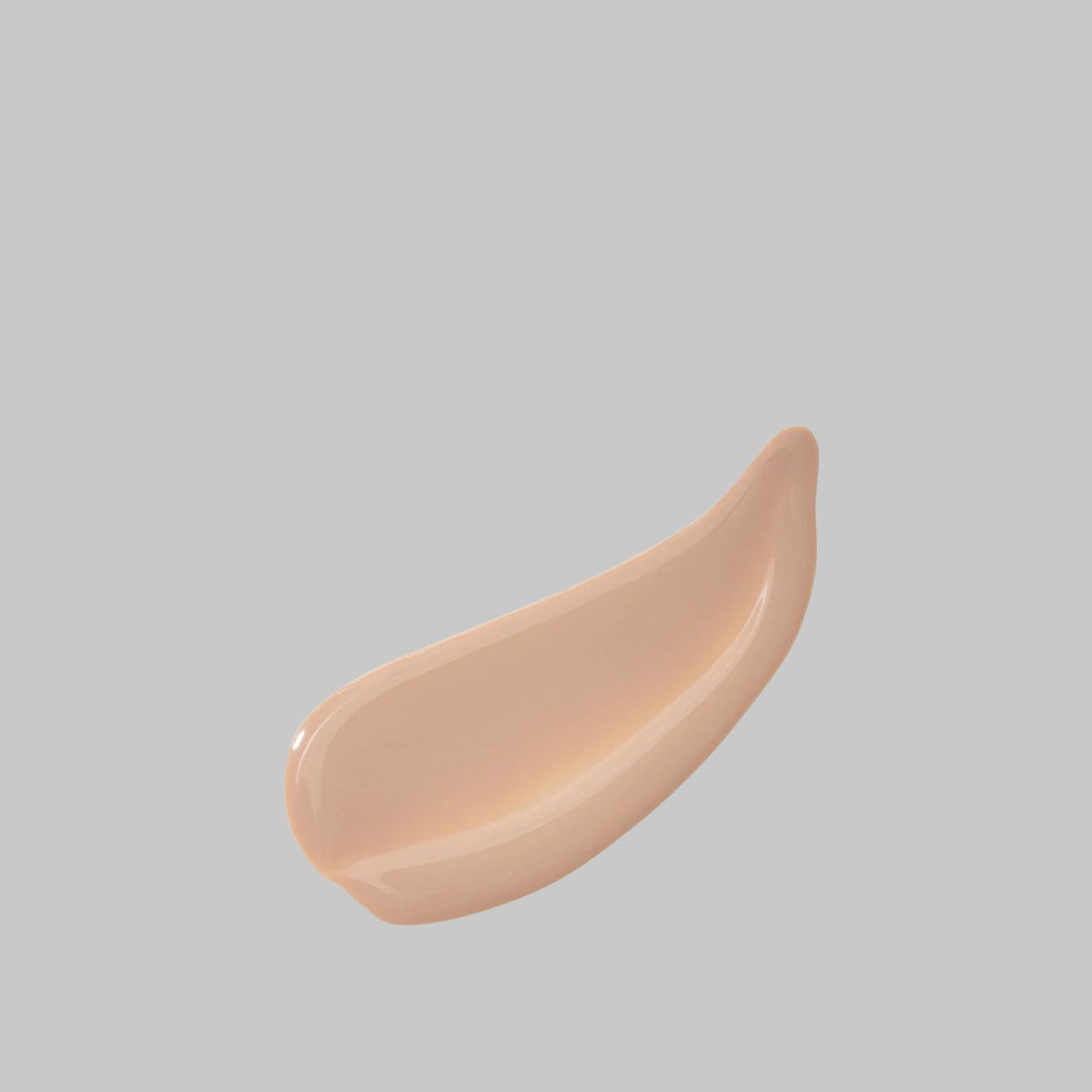 Peach-beige swatch of Bloomeffects Tulip Dew Sunscreen Serum showing its smooth, creamy texture.